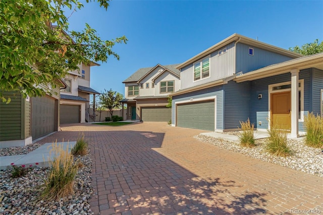 view of front of home with decorative driveway and an attached garage