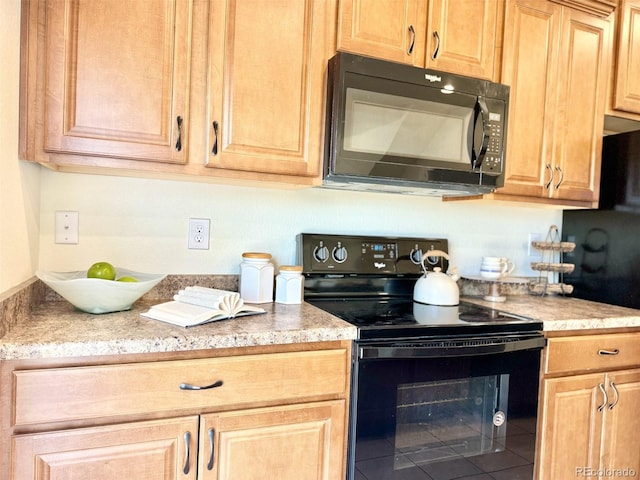 kitchen featuring light brown cabinets, light countertops, and black appliances