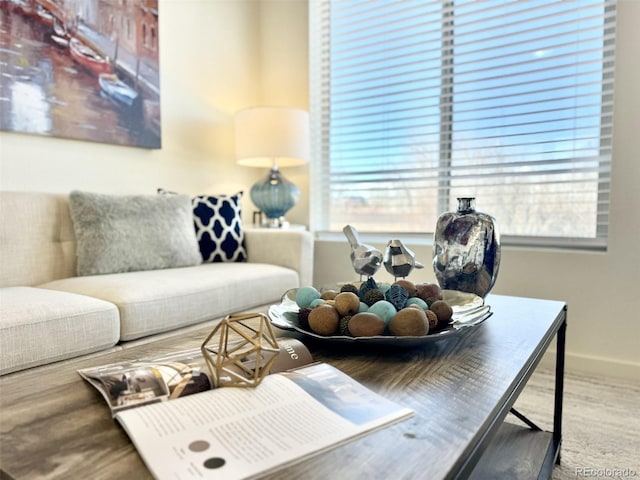 living room featuring baseboards, wood finished floors, and a healthy amount of sunlight