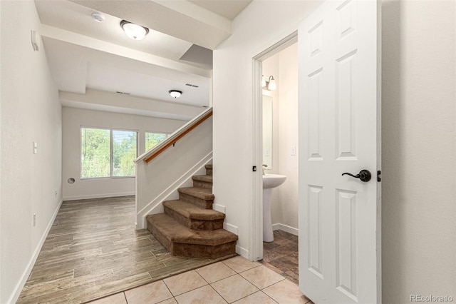 stairway with baseboards and wood finished floors