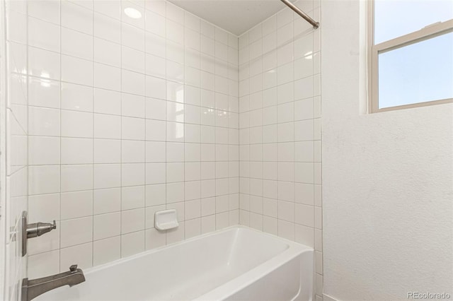 bathroom with washtub / shower combination