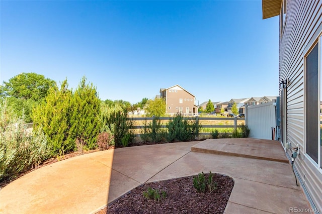 view of patio / terrace featuring fence and a residential view