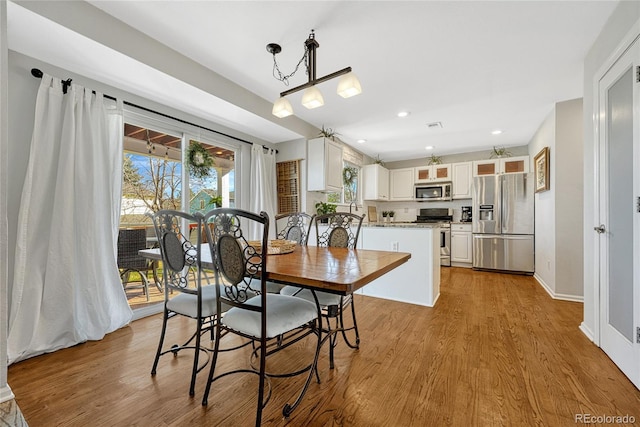 dining area with light hardwood / wood-style floors