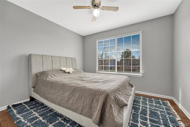 bedroom featuring ceiling fan and dark hardwood / wood-style floors