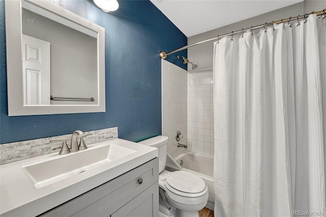 full bathroom featuring vanity, shower / tub combo with curtain, and toilet