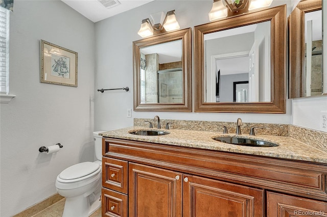 bathroom featuring vanity, tile patterned floors, and toilet