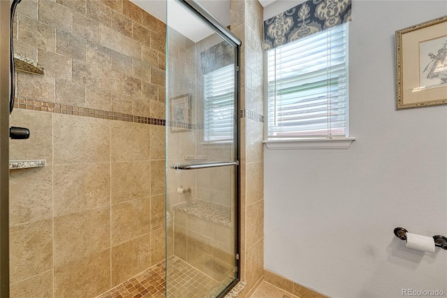 bathroom featuring a shower with door