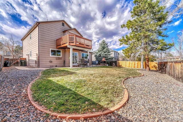 back of house with a lawn, a patio, and a deck