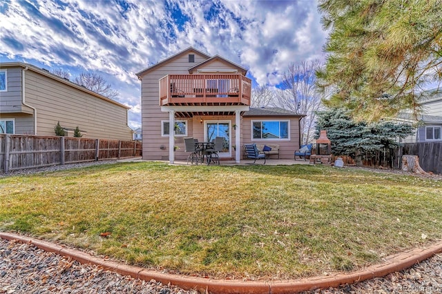 rear view of house with a yard and a patio area