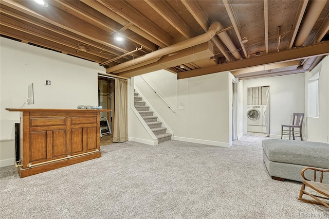 basement featuring separate washer and dryer and light carpet