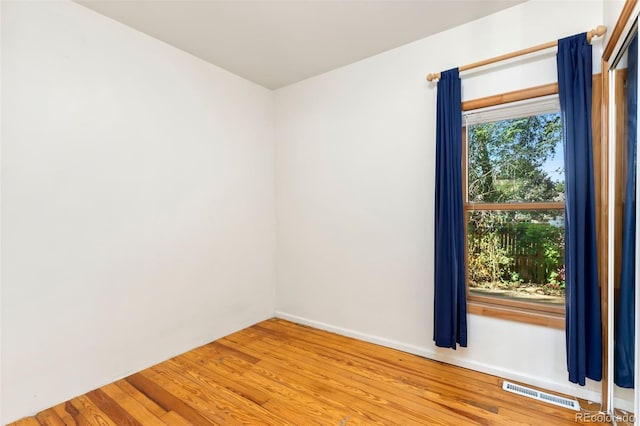 empty room with hardwood / wood-style floors