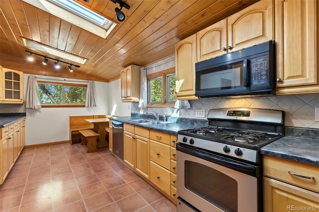 kitchen with appliances with stainless steel finishes, sink, backsplash, wood ceiling, and tile patterned floors