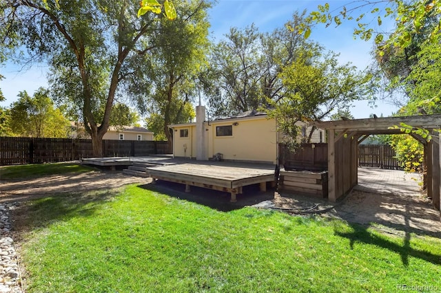 back of house with a wooden deck, a yard, and a pergola