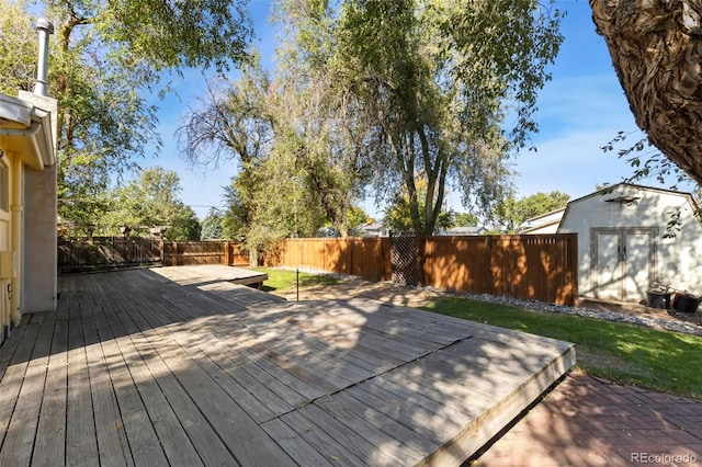 wooden terrace with a storage shed