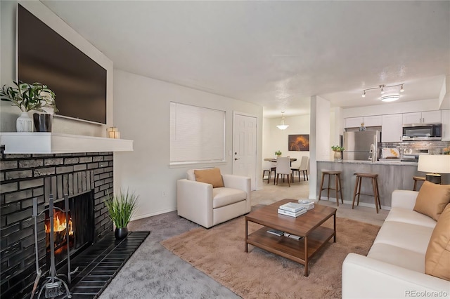 living room with light colored carpet and a fireplace