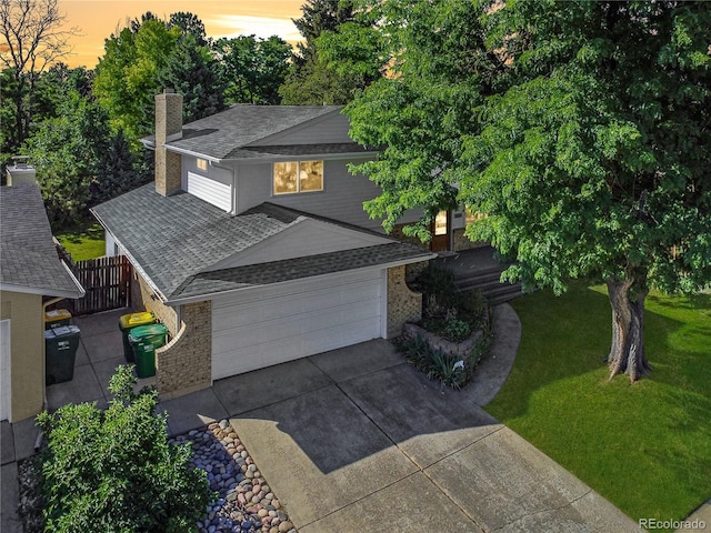 6584 S Clermont Ct, Centennial, CO 80121 - view of front of home featuring a shingled roof, a chimney, brick siding, and concrete driveway