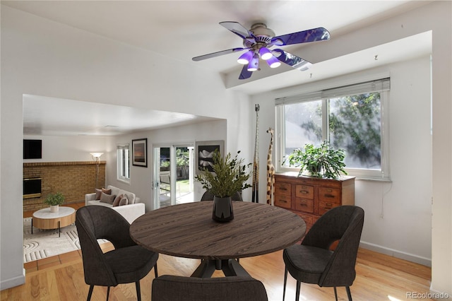 6584 S Clermont Ct, Centennial, CO 80121 - dining room featuring a ceiling fan, light wood-type flooring, plenty of natural light, and a brick fireplace