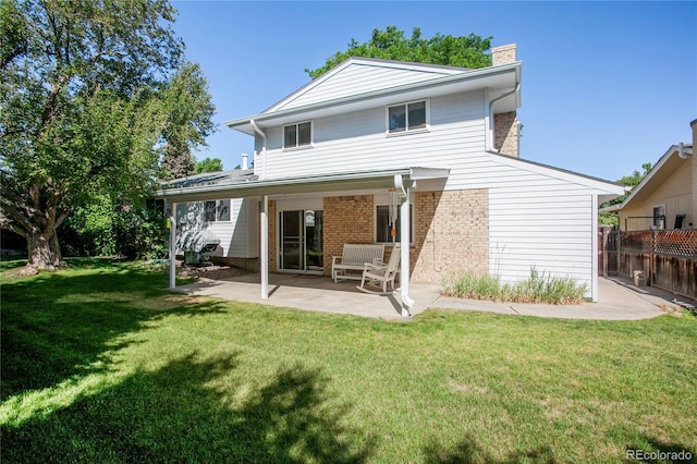 6584 S Clermont Ct, Centennial, CO 80121 - back of property featuring a patio, a chimney, and brick siding