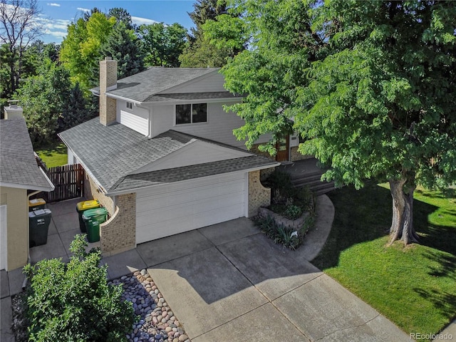 6584 S Clermont Ct, Centennial, CO 80121 - view of front of house featuring brick siding, a shingled roof, a chimney, and concrete driveway