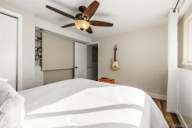 bedroom with ceiling fan and dark hardwood / wood-style floors