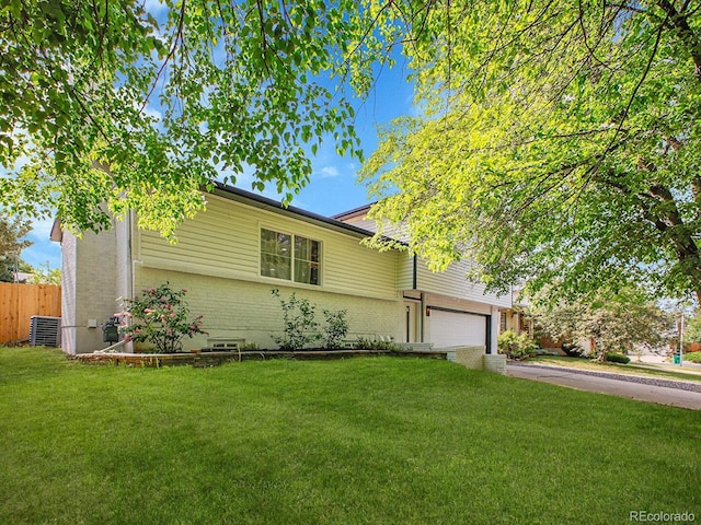 1517 S Elkhart St, Aurora, CO 80012 - view of front of home with brick siding, driveway, central air condition unit, and a garage