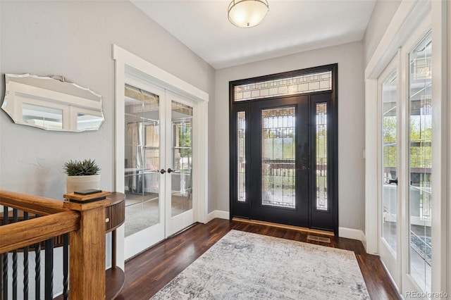 foyer entrance featuring french doors, dark wood-style flooring, and baseboards