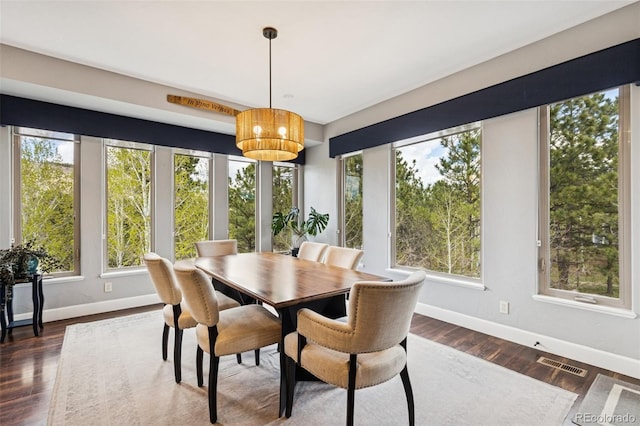 dining room featuring baseboards and dark wood-style floors