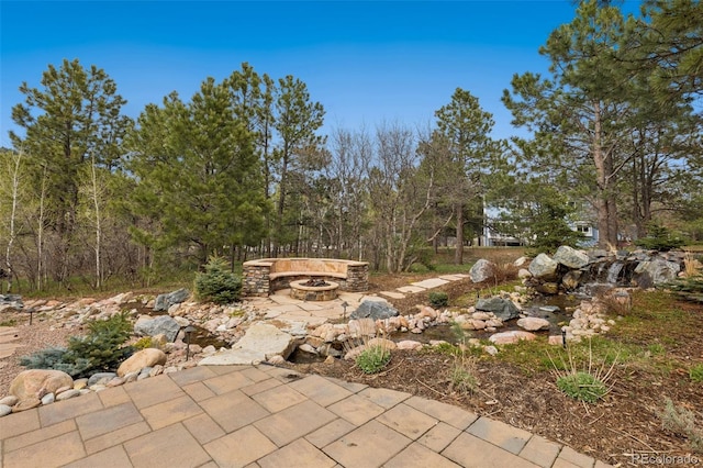 view of patio / terrace featuring an outdoor fire pit
