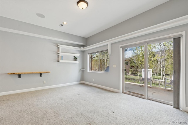 spare room featuring carpet floors and baseboards