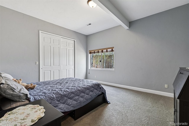 carpeted bedroom featuring beamed ceiling, baseboards, and a closet