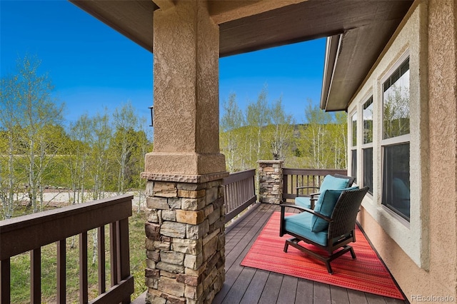 wooden deck with a forest view