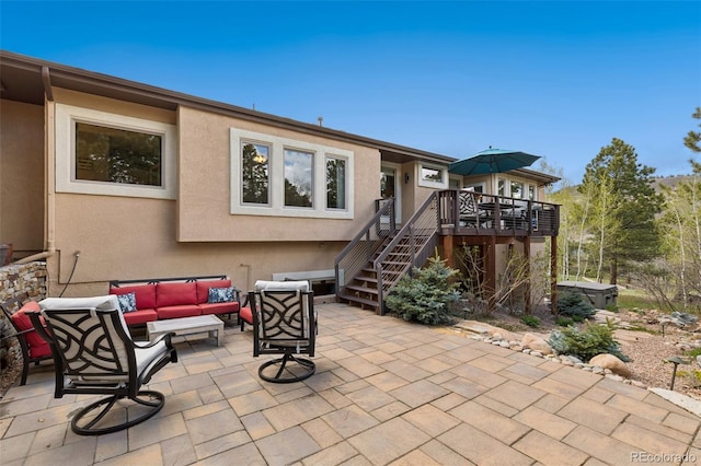 back of house with an outdoor hangout area, a patio area, a deck, stairs, and stucco siding