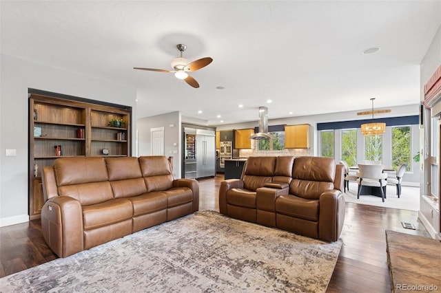 living area with a ceiling fan, dark wood finished floors, baseboards, and recessed lighting