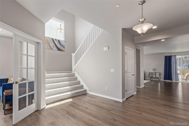 foyer entrance featuring stairs, wood finished floors, baseboards, and recessed lighting