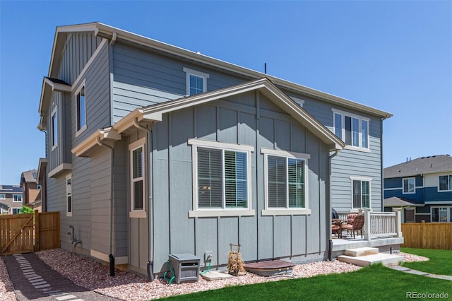 rear view of property with board and batten siding