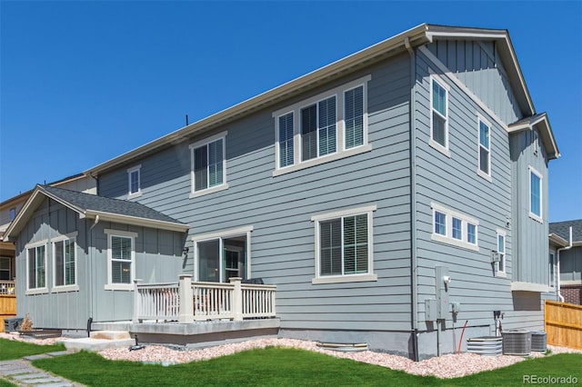 back of house with a wooden deck and board and batten siding
