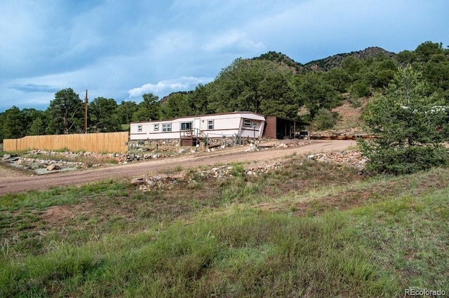 25500 US Highway 50, Cotopaxi, CO 81223 - back of house featuring dirt driveway, a wooded view, and a mountain view