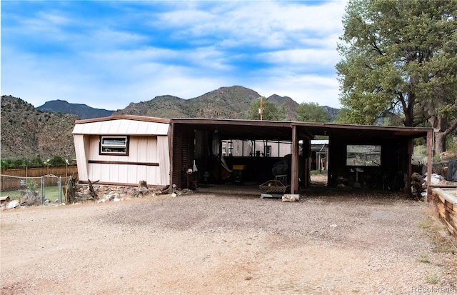 25500 US Highway 50, Cotopaxi, CO 81223 - view of front of home featuring a mountain view, an outdoor structure, dirt driveway, and a carport