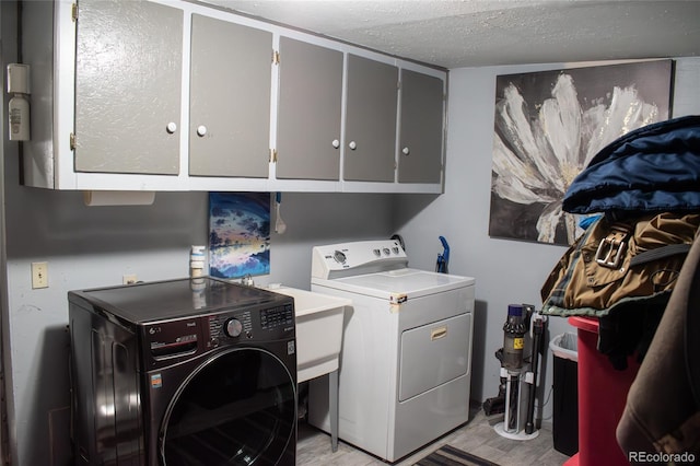25500 US Highway 50, Cotopaxi, CO 81223 - laundry room featuring cabinet space, separate washer and dryer, a textured ceiling, and light wood-style flooring