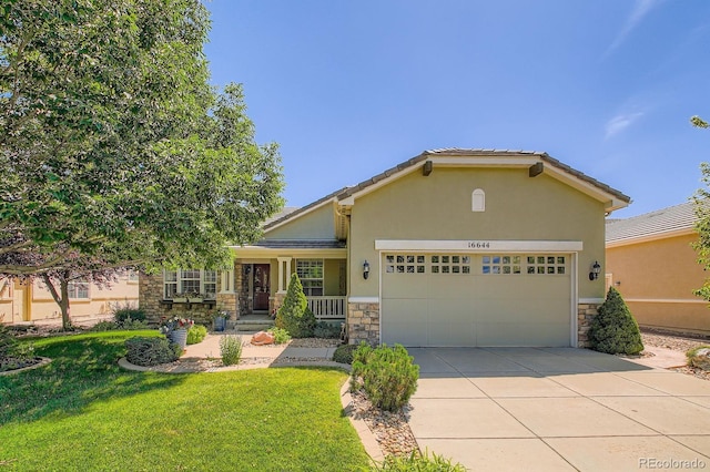 16644 Eolus Way, Broomfield, CO 80023 - view of front of house featuring stone siding, an attached garage, a front yard, driveway, and stucco siding