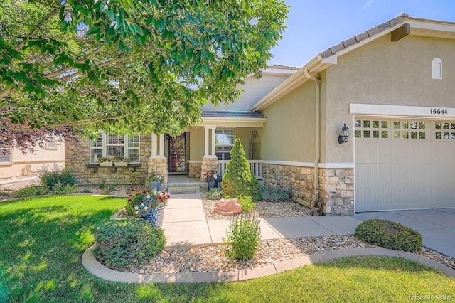 16644 Eolus Way, Broomfield, CO 80023 - view of front facade with stone siding, stucco siding, an attached garage, a front yard, and covered porch