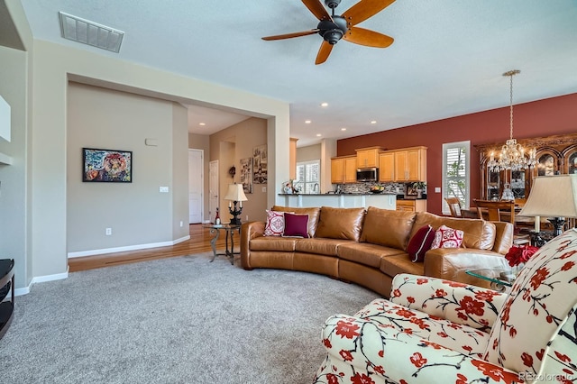 16644 Eolus Way, Broomfield, CO 80023 - carpeted living room featuring a chandelier, plenty of natural light, ceiling fan, and recessed lighting