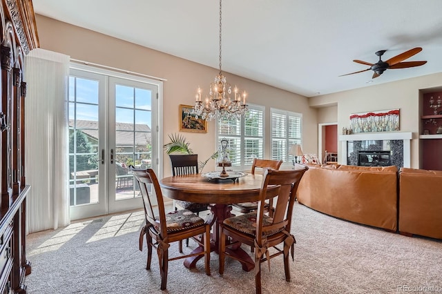 16644 Eolus Way, Broomfield, CO 80023 - carpeted dining area with french doors, healthy amount of natural light, a fireplace, and a ceiling fan