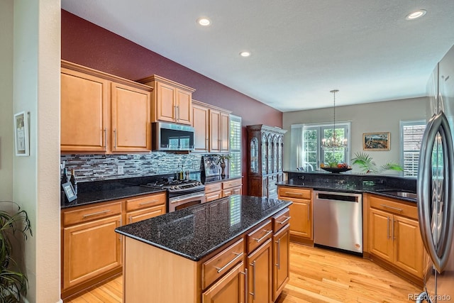 16644 Eolus Way, Broomfield, CO 80023 - kitchen with appliances with stainless steel finishes, light wood-style floors, decorative backsplash, recessed lighting, and a center island