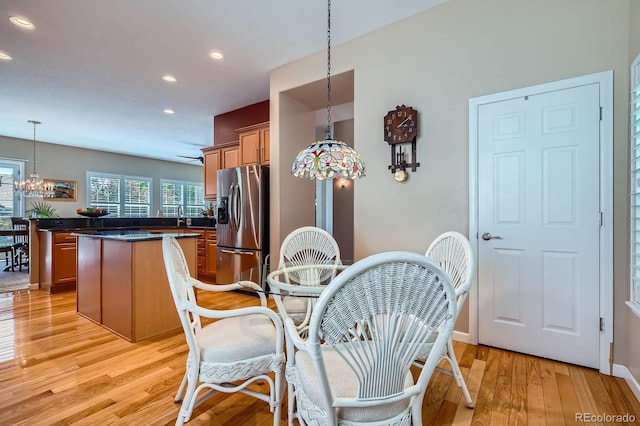 16644 Eolus Way, Broomfield, CO 80023 - dining room with recessed lighting, light wood finished floors, and a chandelier