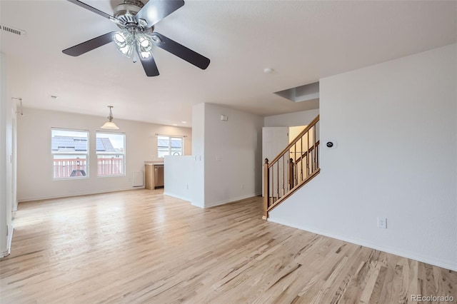 unfurnished living room featuring ceiling fan and light wood-type flooring