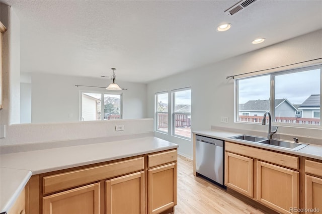 kitchen featuring light brown cabinetry, pendant lighting, sink, light hardwood / wood-style floors, and dishwasher