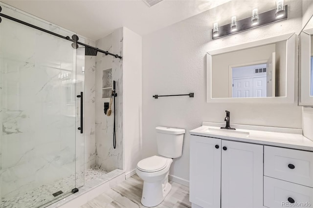 bathroom featuring vanity, toilet, and an enclosed shower