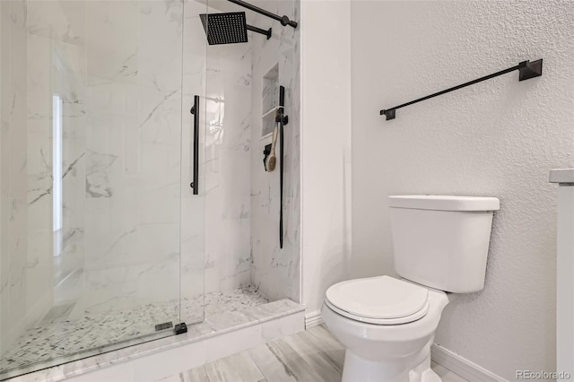 bathroom featuring walk in shower and toilet