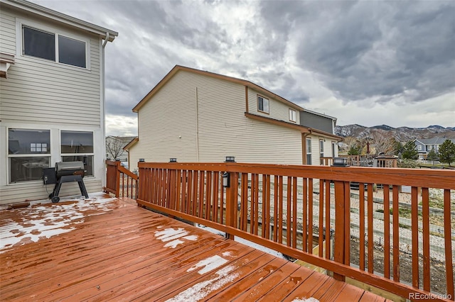 wooden terrace with a mountain view and a grill